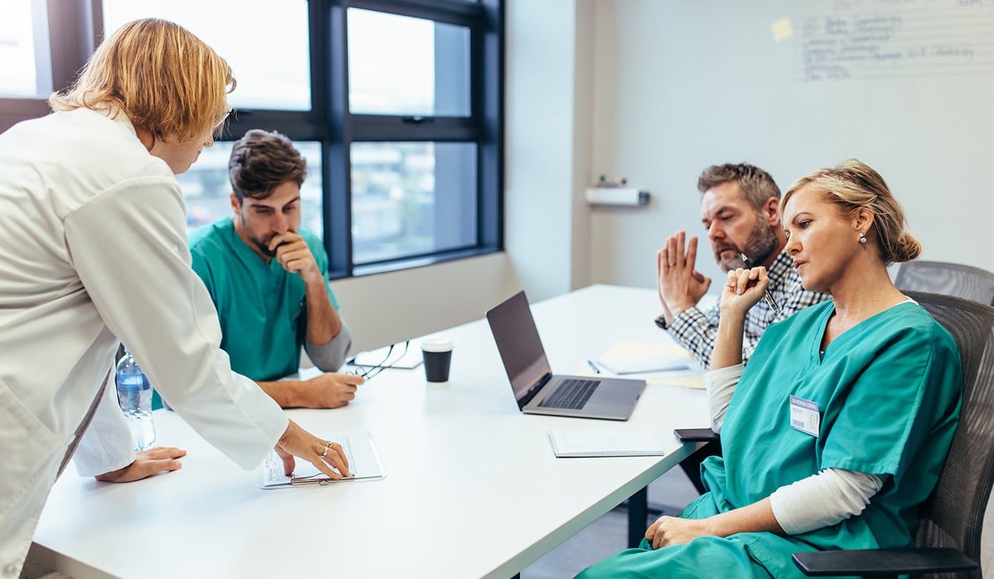 group of medical professionals brainstorming in meeting